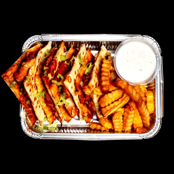 Chicken quesadillas with fries and a side of ranch dressing in a foil container.